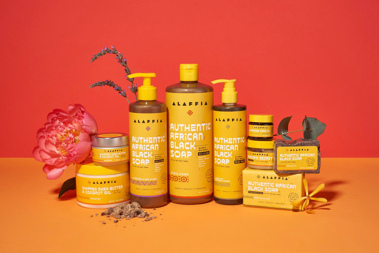 Alaffia product line including bottles and bars on a red and orange background