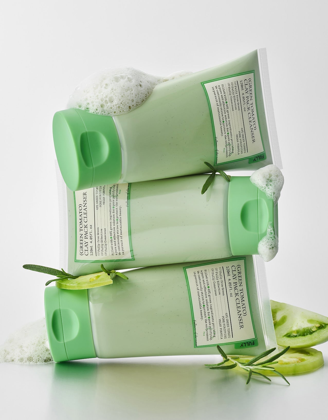Three green skincare products with labels on a white background